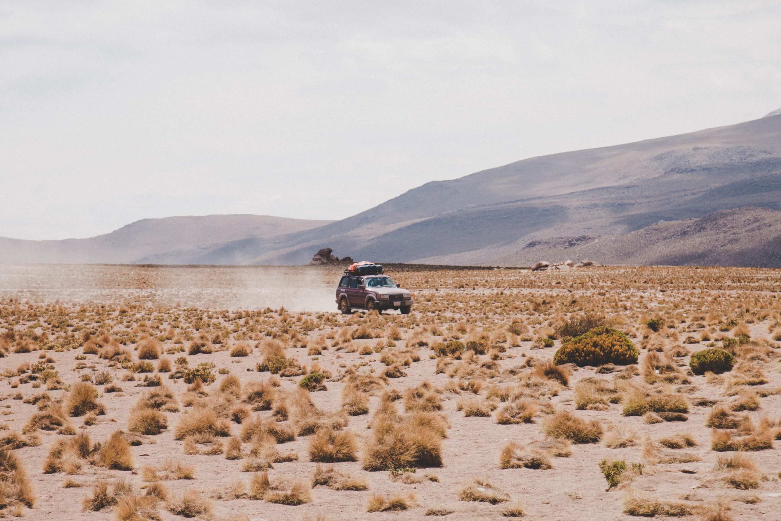 Australia's Best Touring Locations - 4x4 vehicle driving across desert