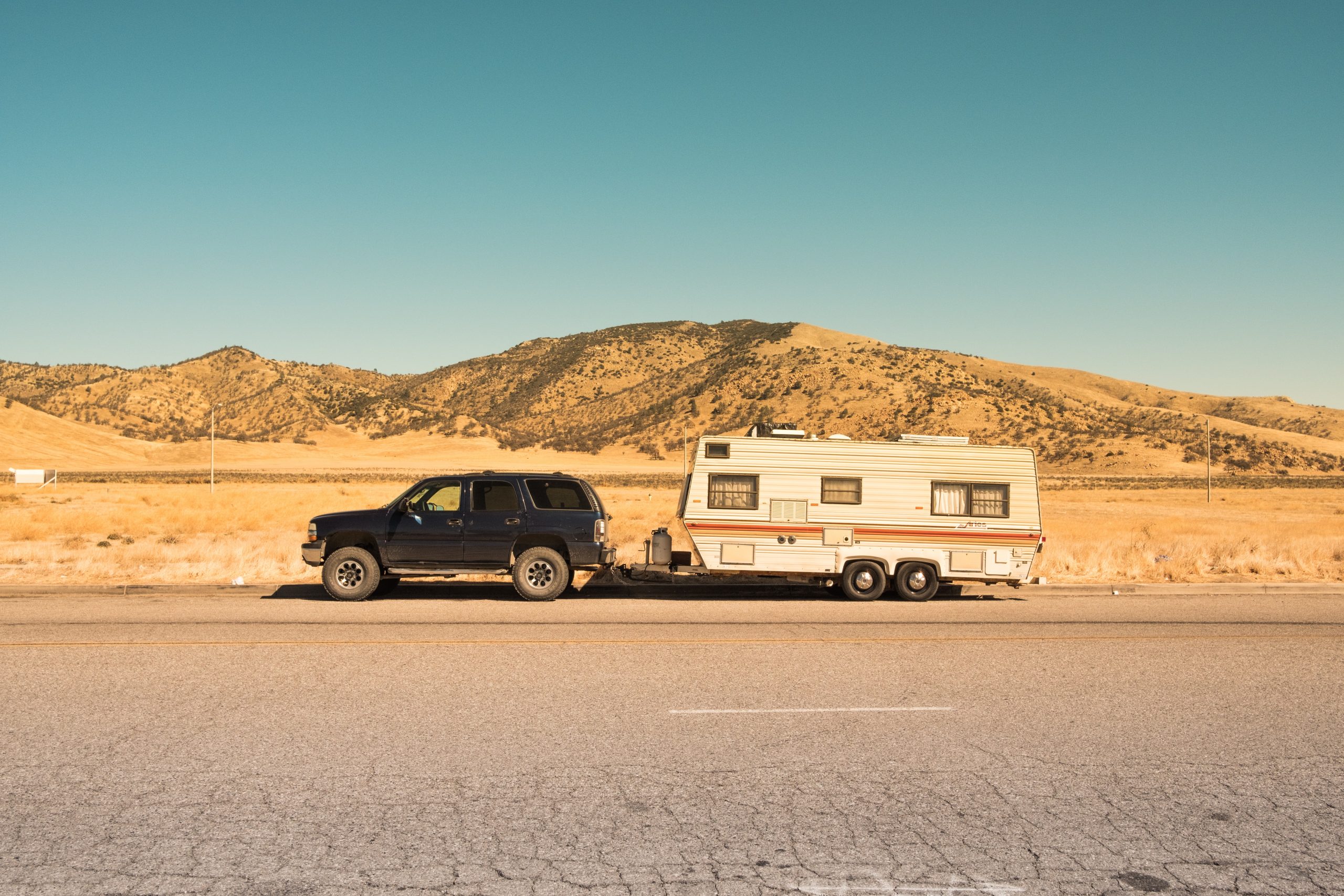 Towing A Trailer: Top Tips and Upgrade Opportunities - black SUV with caravan