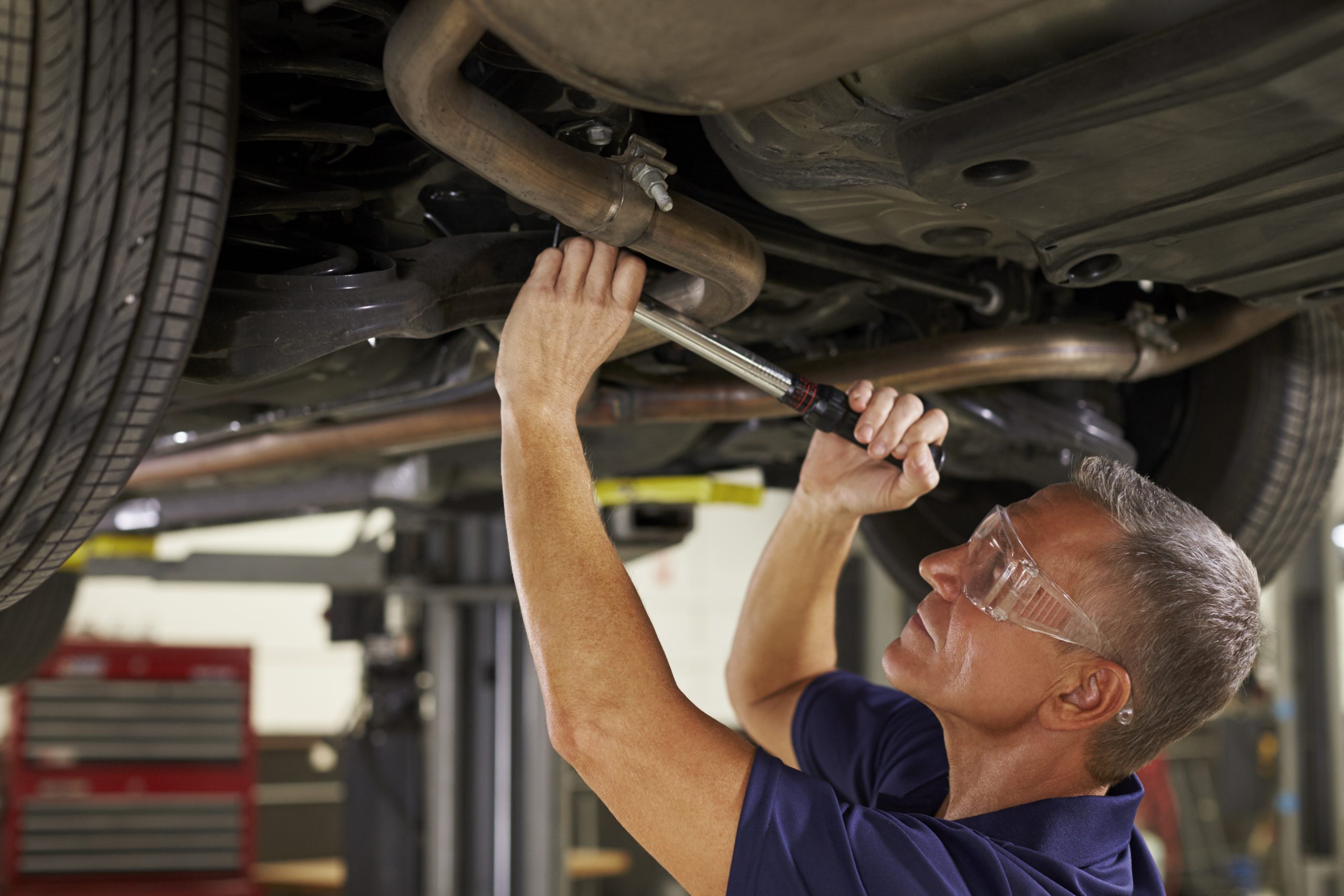 Why You Need an Oil Catch Can with Your EGR System - man working on underside of a car