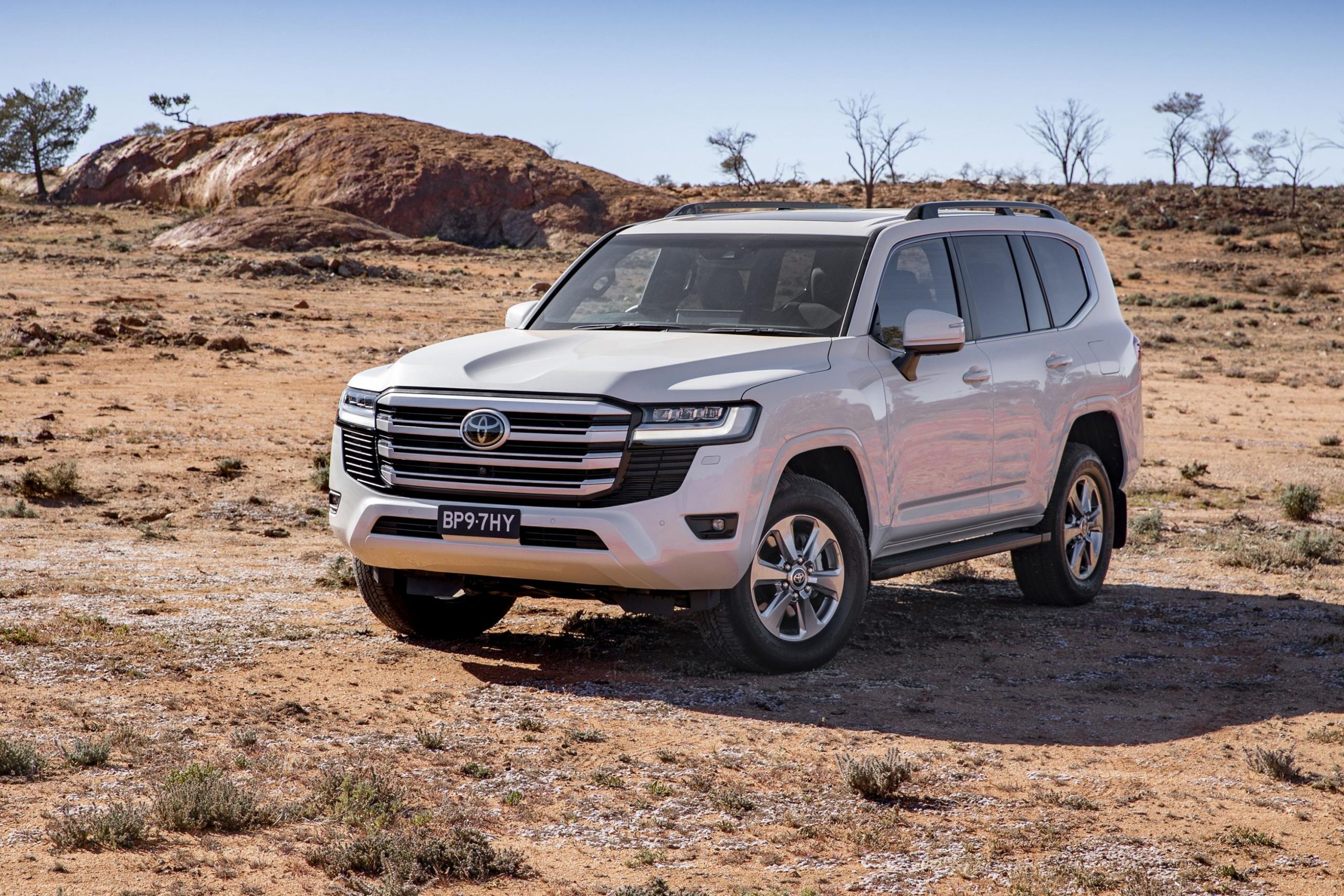 Toyota LandCruiser 300 Series - white Toyota LandCruiser on dusty road