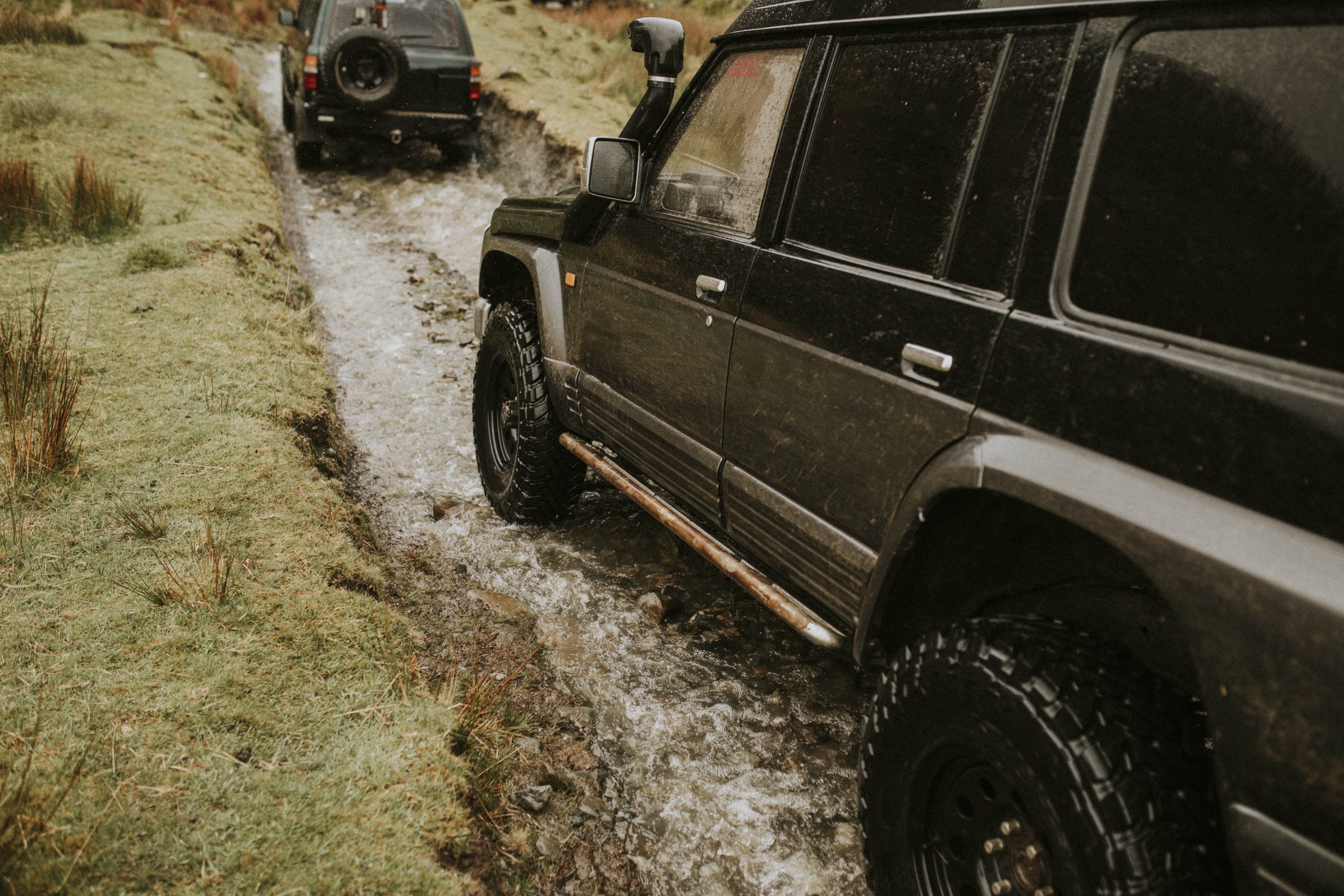 3 Ways ECU Tuning Changes Your Performance - side view of an SUV driving through mud and water