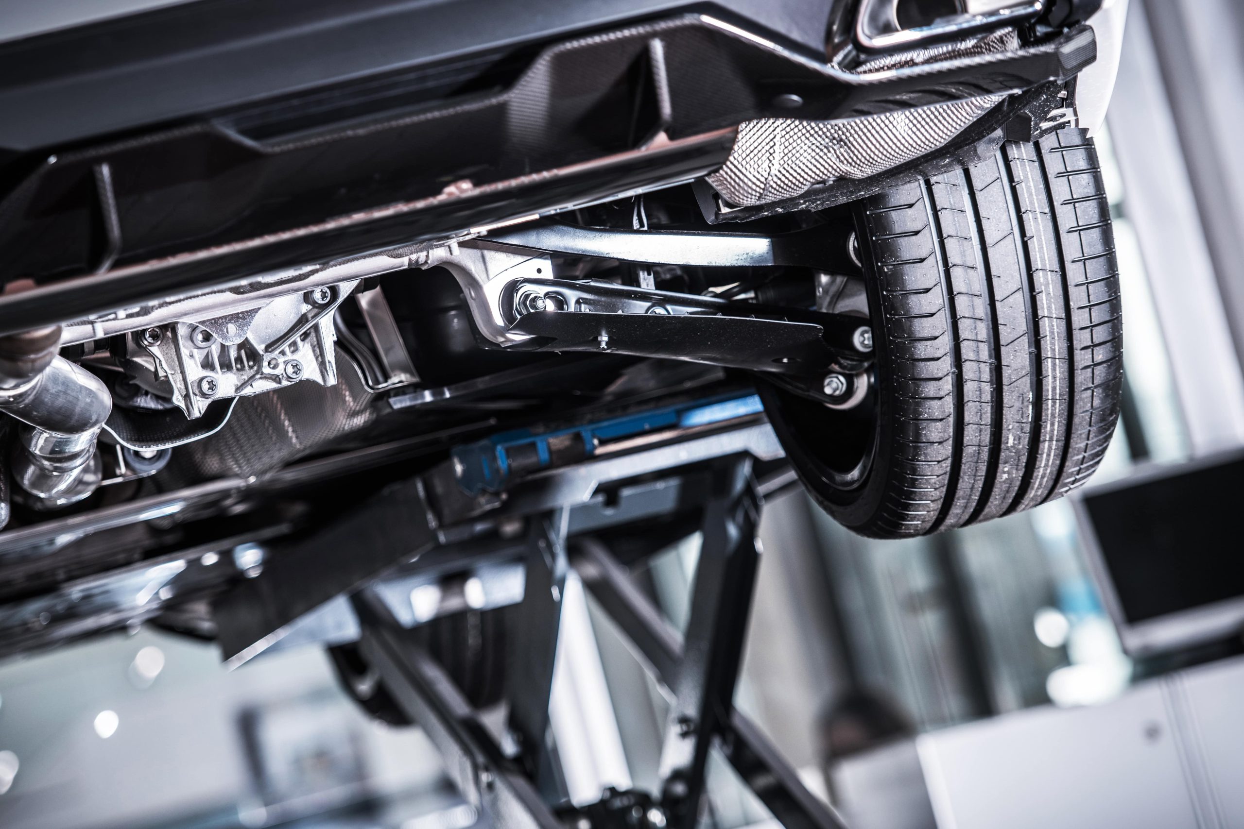 What is Second Stage Manufacturing? - close up of the underside of a car on a jack