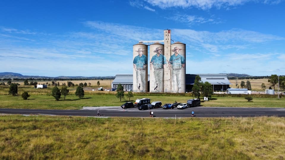 Towing Essentials for Caravans and Trailers - vehicles parked in front of silos