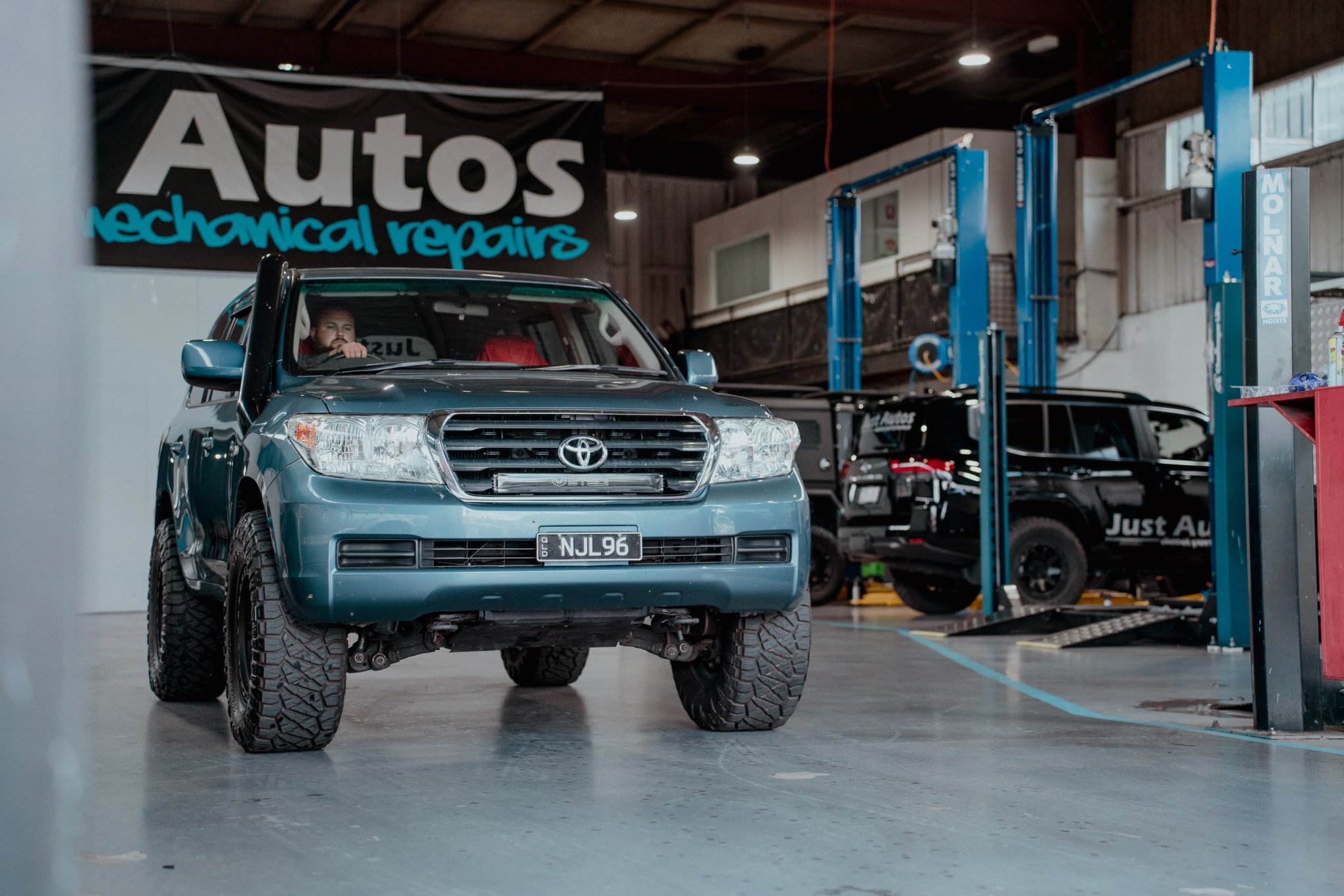 Diesel Performance Tuning - Just Autos technician driving a Hilux