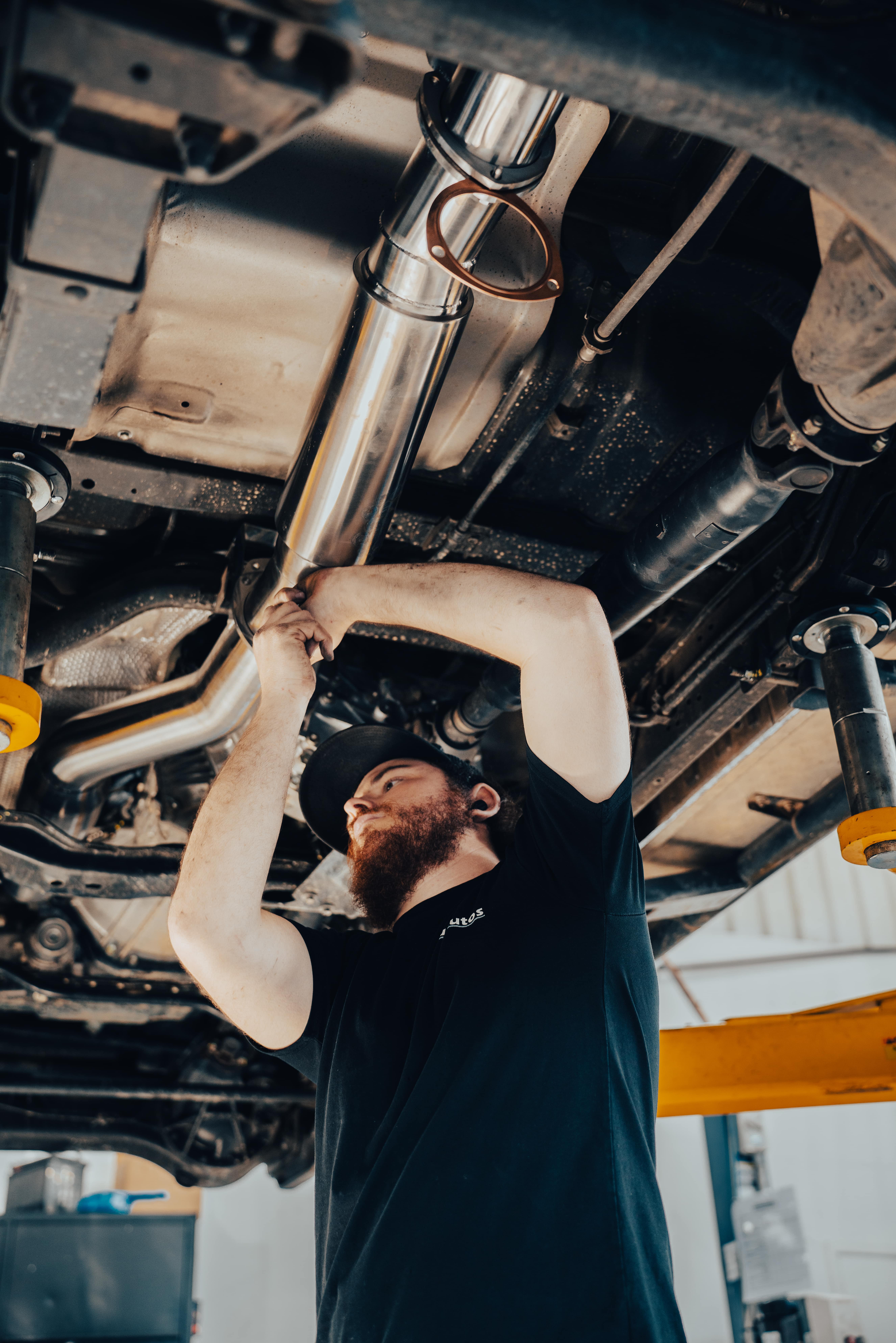 Just Autos diesel performance technician working on custom performance exhaust system