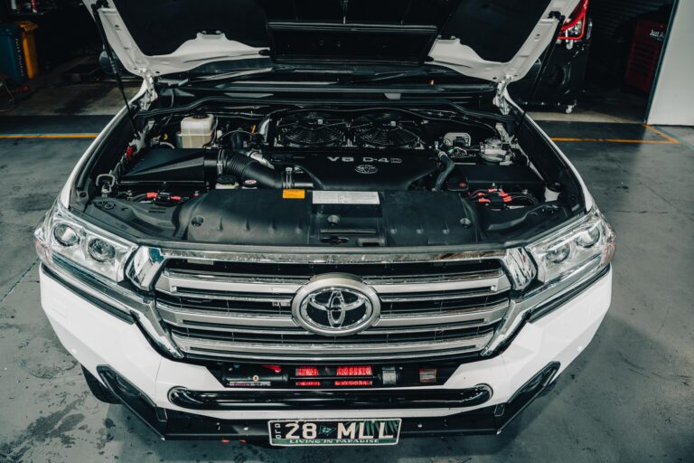 Open bonnet of a Toyota Hilux being worked on at Just Autos
